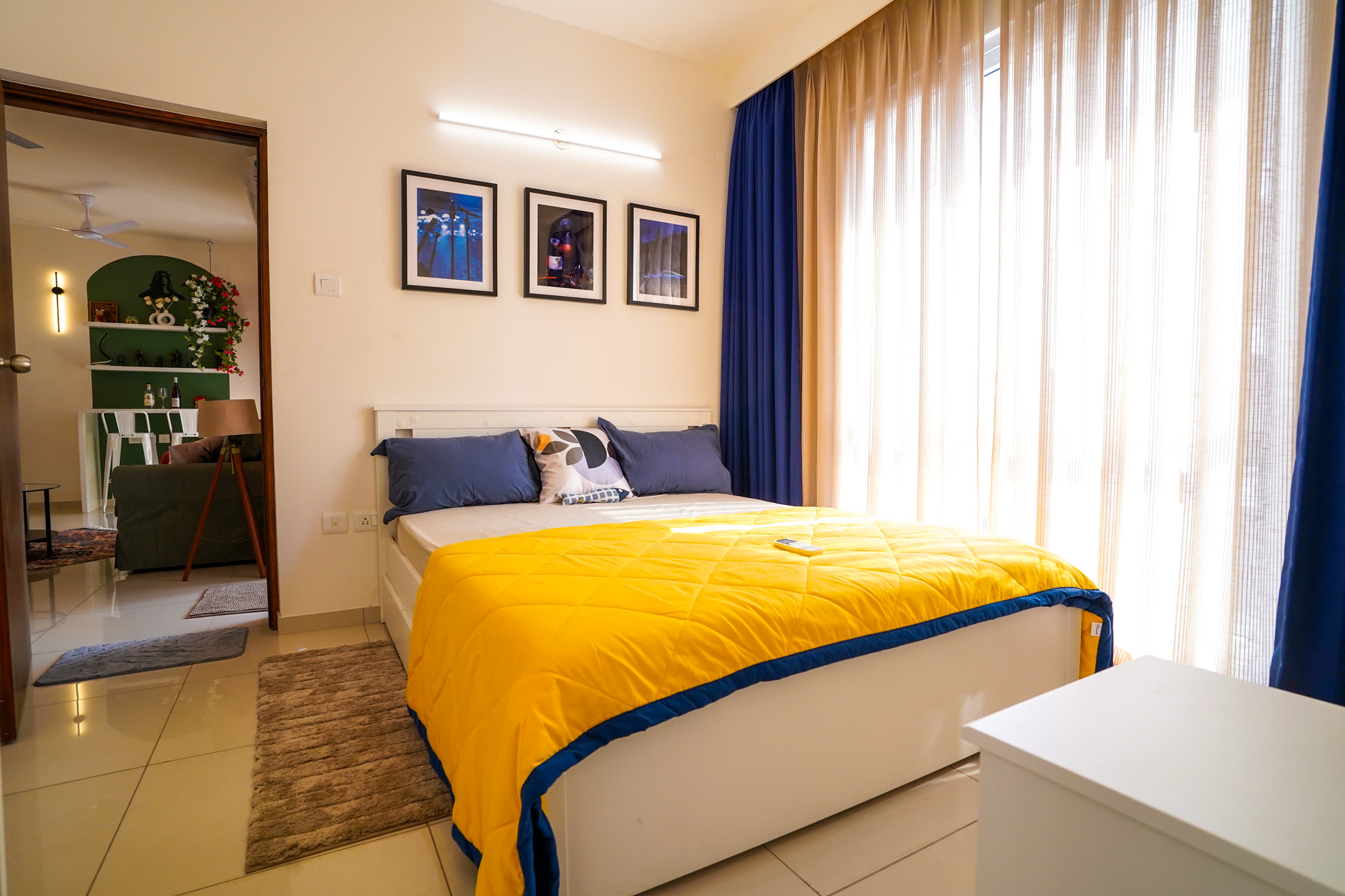 Master bedroom with yellow bedding and blue curtains