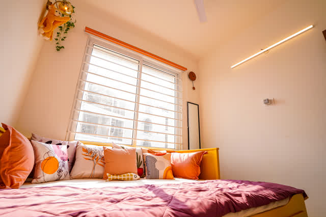 Coral bedroom pillows and window light